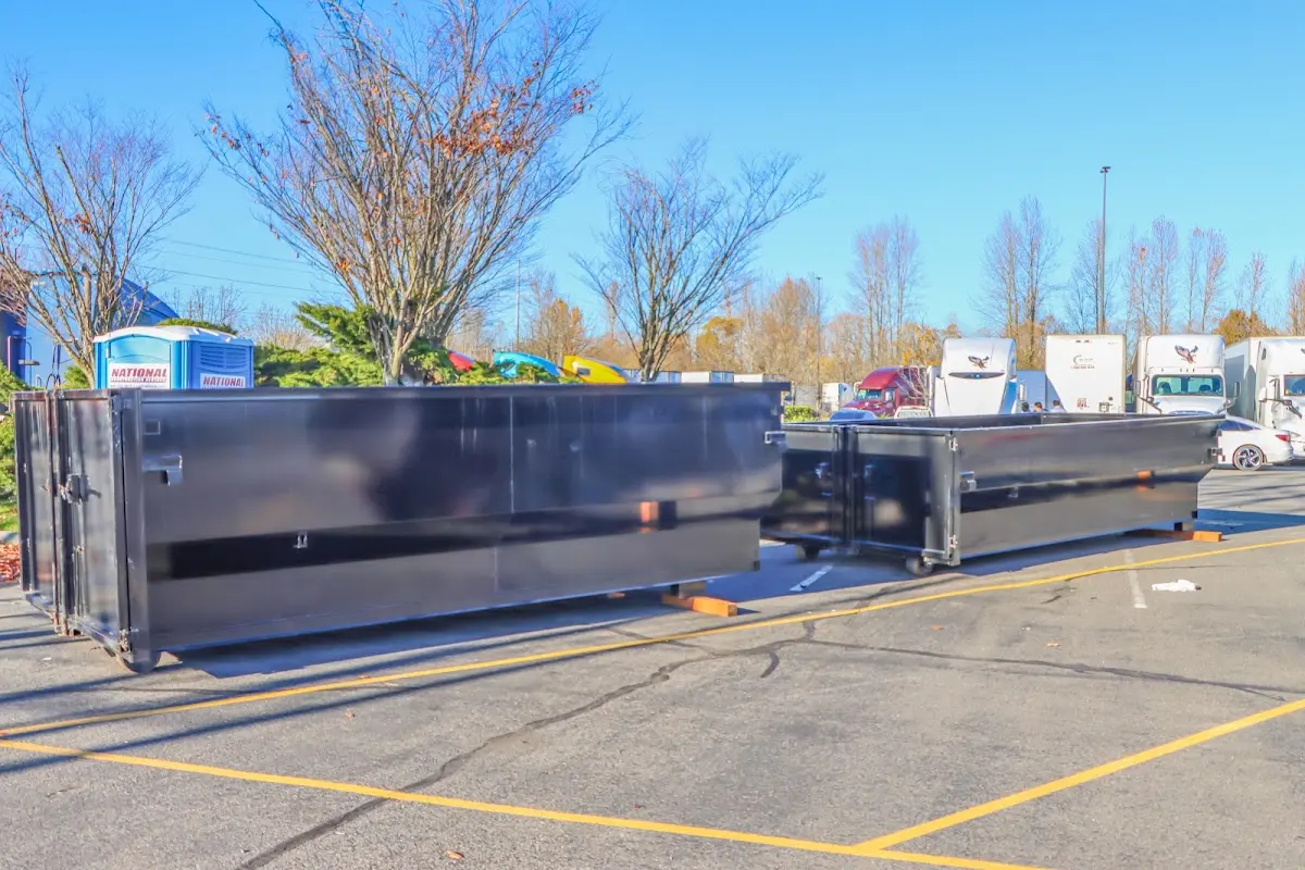 Professional dumpster rental service with roll-off container on residential driveway in Sheboygan Falls